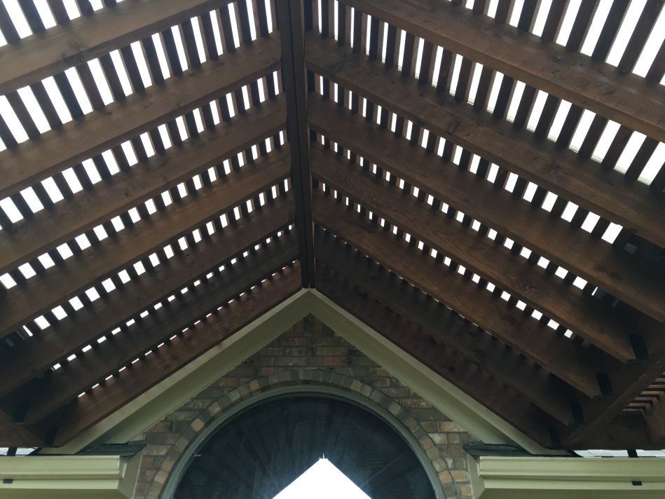Detail image of gabled roof on pergola.